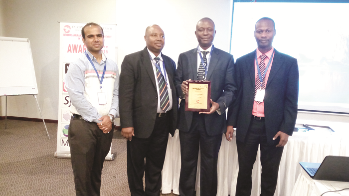 The Subah team at the forum. They are from right: Mr Daniel Maafo, General Manager, Operations; Mr Redeemer Kwame, Director (holding the award); Mr Emmanuel Hudson-Odoi, Business Development and Marketing Manager and Mr Seth Mhagnan, Revenue Assurance Officer